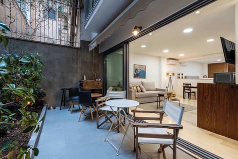 The private patio extends the living space outdoors, creating a welcoming setting for morning coffee, outdoor dining, or relaxing after a day exploring Athens.