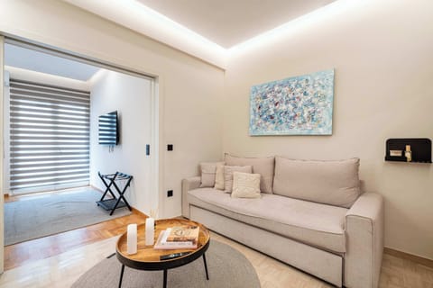 The bright living area combines comfortable seating, contemporary design, and natural light, creating a welcoming space to relax, socialise, or plan your next day in Athens.