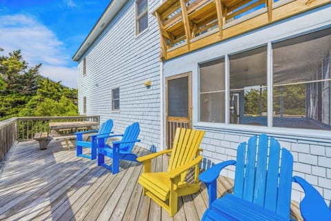 Settle into a colorful Adirondack chair on your private deck, where sunny skies and coastal breezes create the perfect backdrop for morning coffee or afternoon relaxation.
