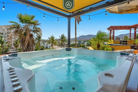 Relax in a private jacuzzi with stunning mountain and palm views. Shaded lounge area with string lights creates the perfect spot to unwind, soak, and enjoy peaceful sunsets in a tropical setting.