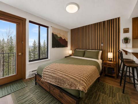 Sink into the plush bedding and wake to mountain views from your window. The open-concept space features a full kitchen and breakfast bar, perfect for cozy mornings in.