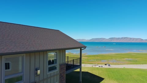 Lakeside home with balcony, mountain views, and steps to the shore
