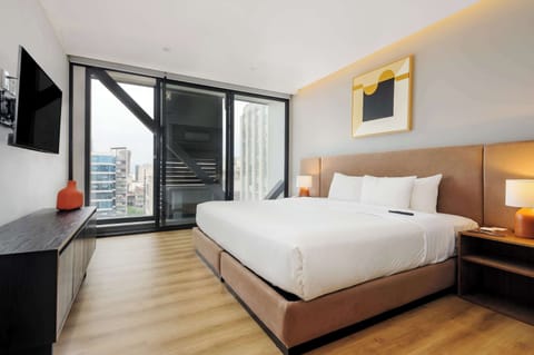Bright bedroom with a comfortable bed.