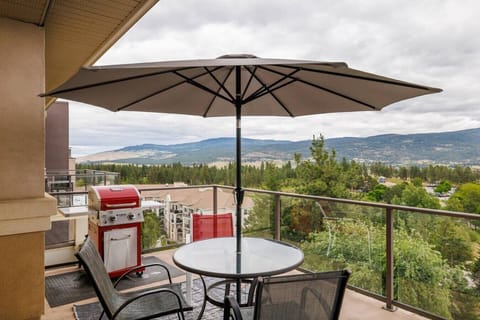 Unwind on the private deck featuring outdoor dining, a barbecue grill, and a lovely view.