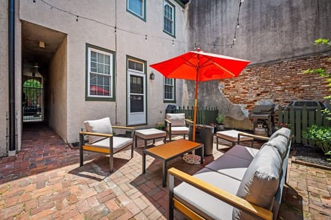 Charming private courtyard with lounge seating, grill, and café-style ambiance