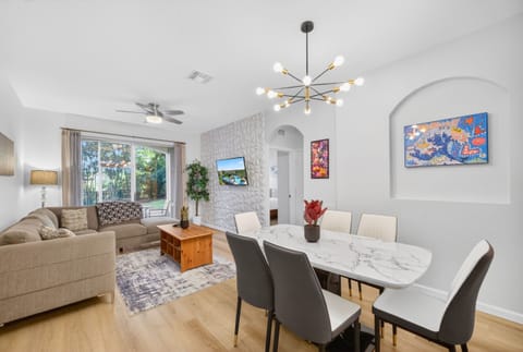 Bright open living-dining space with garden views and stylish modern décor