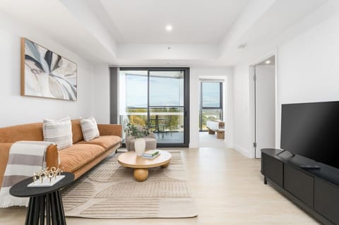 Large windows fill the living area with natural light, creating a bright and welcoming space throughout the day.
