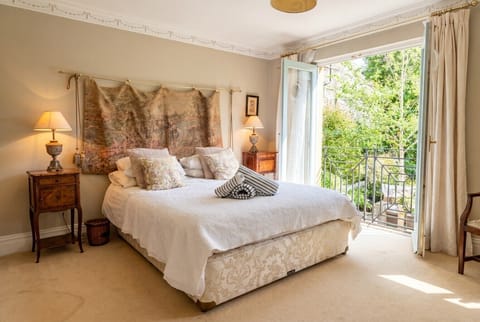 Wake to garden views from the master with king bed and French doors to the balcony.