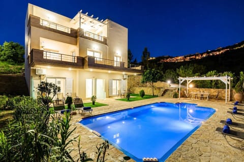 The shared pool area comes alive after sunset, offering a peaceful setting beneath the Cretan night sky.