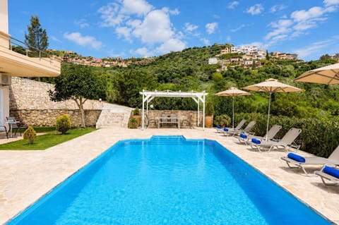 Relax by the large shared swimming pool, surrounded by beautiful countryside views, sun loungers, and plenty of space to unwind under the Cretan sun.