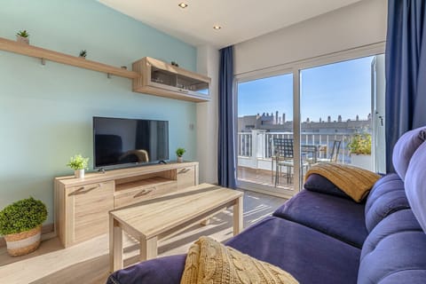 Relax in the bright and airy lounge of this Marbella beachside rental, offering natural Andalusian sunlight and sliding glass doors that open straight onto the private terrace.
