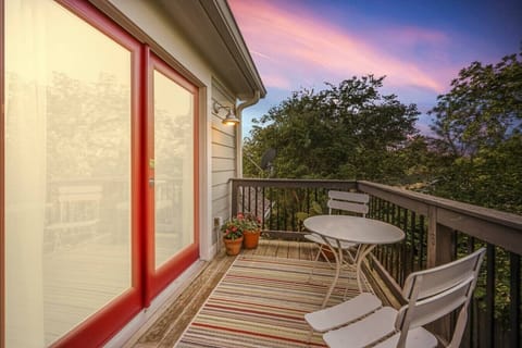 Private balcony featuring a cozy table for two and warm evening light.