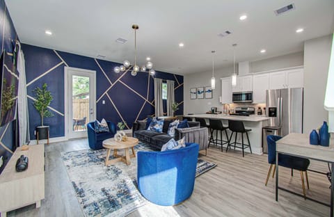 Stylish open-concept living with bold designer accents, a fully equipped kitchen, and cozy lounge seating—perfect for gathering, relaxing, and entertaining.