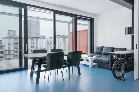 Bright living area with floor-to-ceiling windows and open city views.
