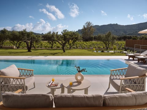 Green landscape embrace the pool area, shaping a serene backdrop for sunlit leis