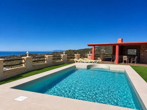 A stunning private pool with panoramic sea and hillside views.