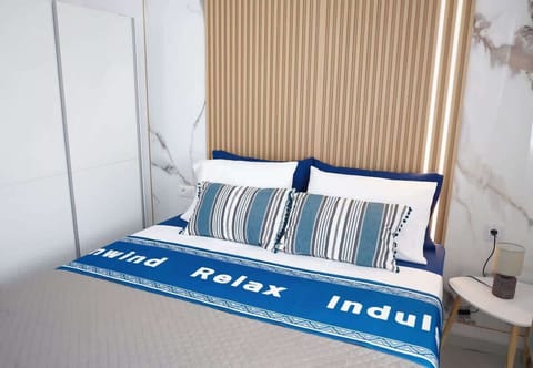 Bright Bedroom with Comfortable Bedding and Blue Accents