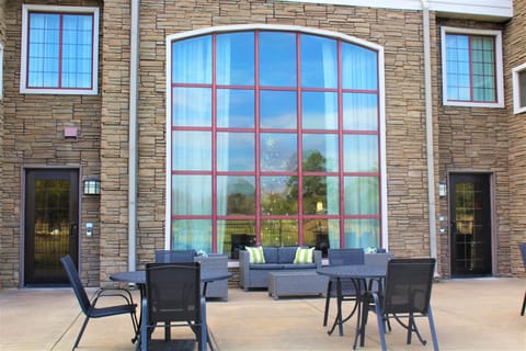 Outdoor seating area with comfortable furniture and greenery.