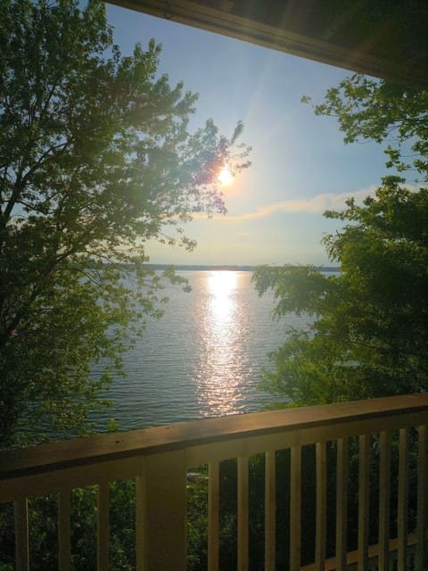Private balcony with serene lake views and glowing sunset reflections