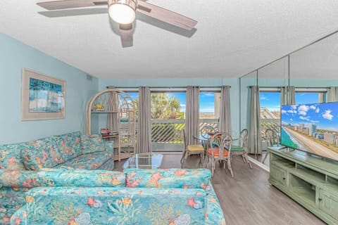 Bright coastal living room with ocean views and plenty of comfortable seating.
