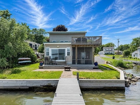 Your dock, your lake, your retreat. Step off the water onto a private dock leading to a screened porch, fire pit patio, and upper deck — all on the shores of Cayuga Lake.