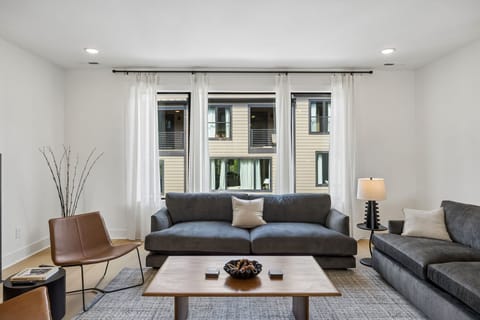 Living Room: A bright living room with natural light and a relaxing layout.