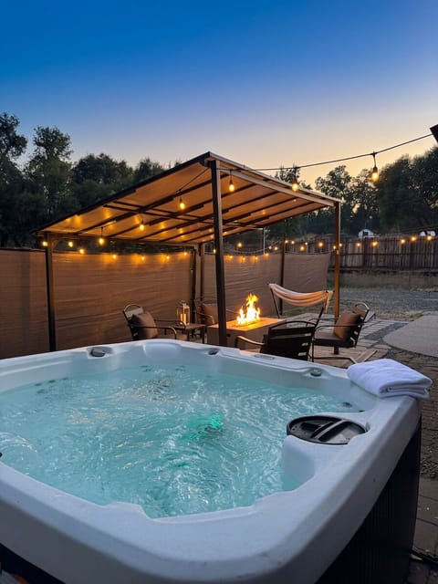 Private hot tub, fire table, and string-lit pergola for cozy evenings