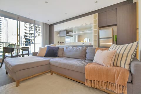 Bright modern lounge with balcony views and stylish open-plan kitchen