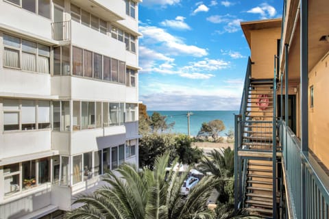 Ocean-view apartment setting with palm trees and easy beachside charm