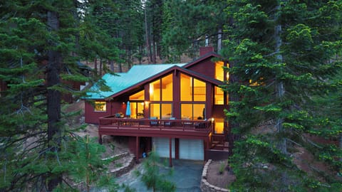 Elevated twilight view emphasizing the cabin’s perfect blend of rustic charm and modern design.