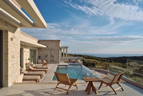 Sea & Land embrace the pool area, shaping a serene backdrop for sunlit leisure a