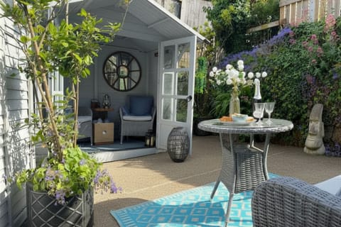 Private courtyard garden with summer house seating and outdoor dining