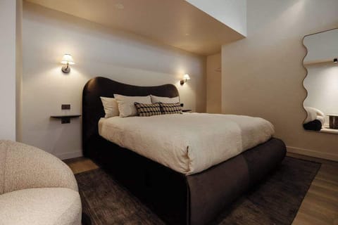 Soft curves and layered textures create a boutique hotel feel.