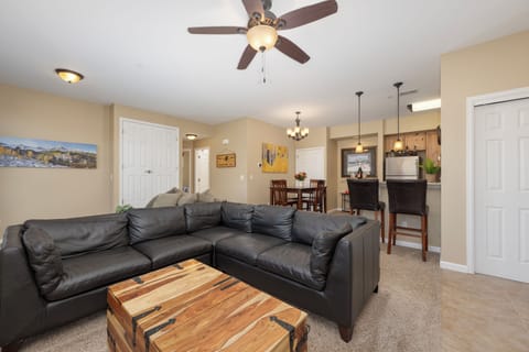 Settle into your open-concept living space where comfort meets convenience. Plush seating flows naturally into the dining area and kitchen, creating the perfect setting for gathering and unwinding together.