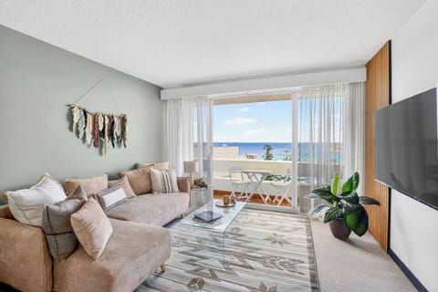 Stretch out on the comfortable lounge with a book or movie as coastal-inspired styling and sweeping ocean views create an inviting backdrop for slow afternoons in Manly.
