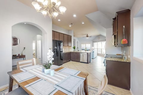 Step into this bright, open kitchen and dining area where you'll find everything you need to cook and share meals. Enjoy the elegant chandelier, modern appliances, and welcoming atmosphere.