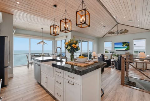 Bright open-concept kitchen and living space with Gulf views, elegant coastal finishes, and plenty of room to cook, gather, and unwind.