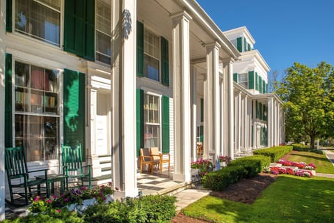 Relax on the porch in the warm sun, surrounded by vibrant flowers and charming greenery.