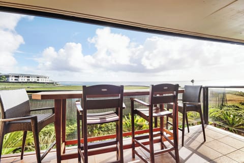 The lanai offers panoramic beauty of tropical vegetation and the ocean.