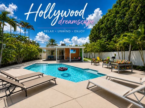 Private tropical pool oasis with loungers, patio seating, and sunny vibes