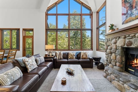 Spacious living room with vaulted ceilings, tons of natural light, fireplace and smart tv