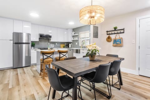 Boho-inspired bright kitchen layout with dining table that seats six