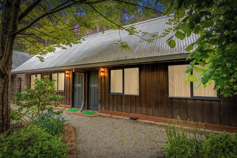Charming woodland cabin exterior with private entrances and lush gardens