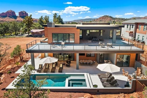 The backyard features everything to entertain your group including a heated pool and spa, firepit, and built-in BBQ.