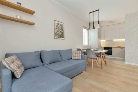 Relax in the stylish living room with a comfortable sofa and modern decor.