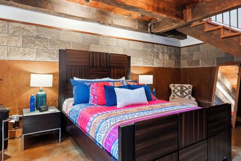 Sink into the plush king bed beneath stunning exposed beam ceilings, where rustic charm meets modern comfort in your private retreat.
