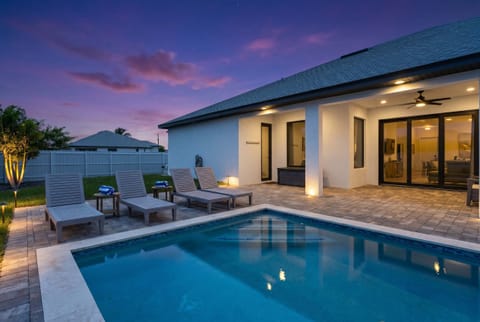  Golden hour hits different when it's your pool. Unwind poolside as the sky puts on a show — lounge chairs ready, lights glowing, vacation mode fully activated.