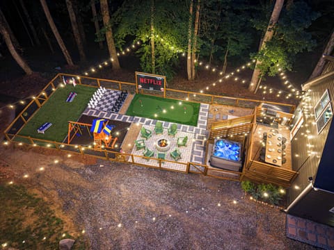 String-lit backyard retreat with hot tub, fire pit, games & outdoor movie screen