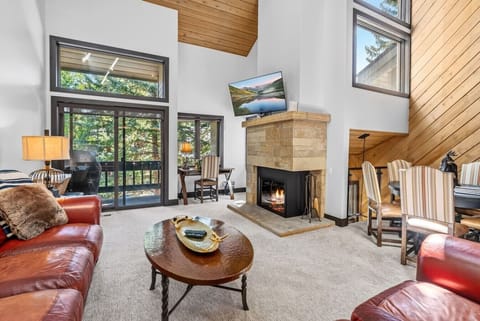 Spacious living room with vaulted ceilings, fireplace, and smart tv