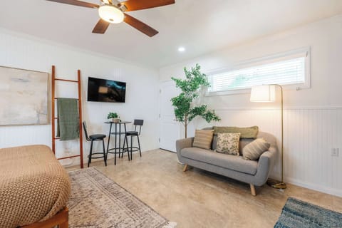 Bright open layout with queen bed, kitchenette, and sitting area
